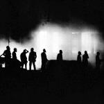 Marshals are silhouetted against a tear gas cloud