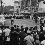 Many of the younger mourners had become overwhelmed with grief and incensed with rage over the killing of Evers. Here Jackson police, with guns drawn and clubs in hand, block their route, refusing to allow the march to continue.